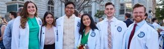 Six 正规澳门赌场网络 medical school students pose in their white coats